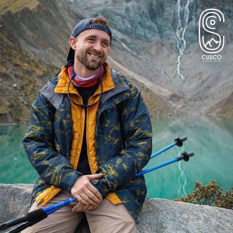 Viajero descansando junto a las aguas turquesa de la Laguna Humantay, Cusco