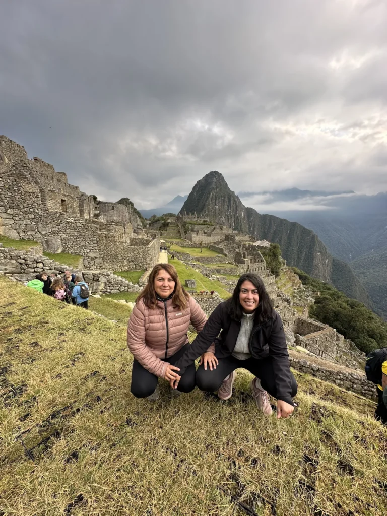 Viajeras en Machu Picchu en una mañana nublada, con Huayna Picchu al fondo