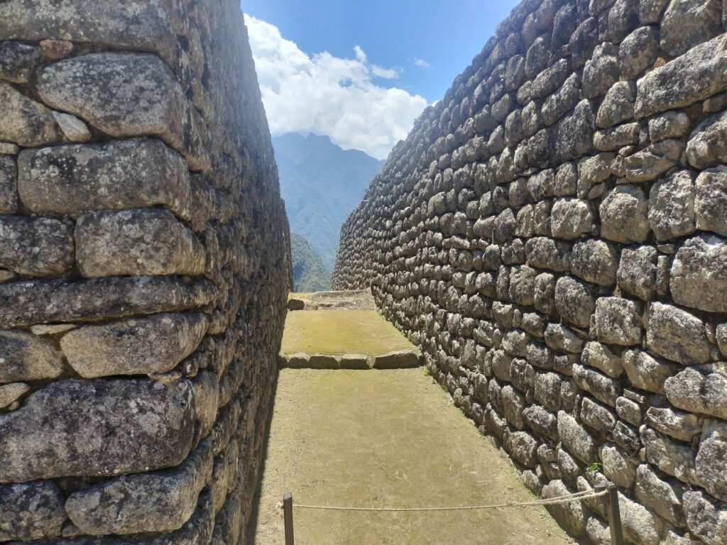 Pasaje entre muros incas de piedra en Machu Picchu